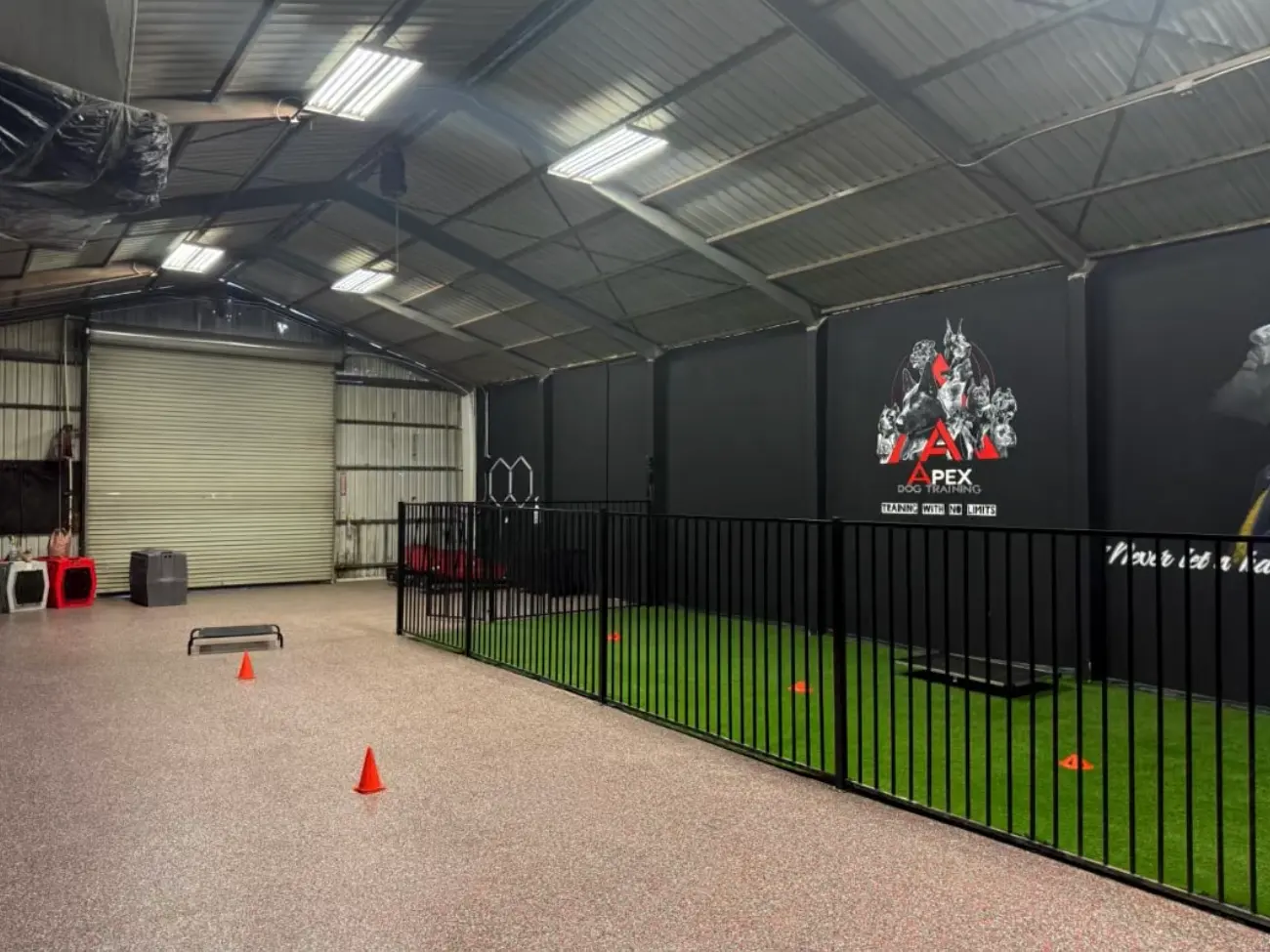 Inside the Apex facility: the fenced turf training field, seen from the entrance